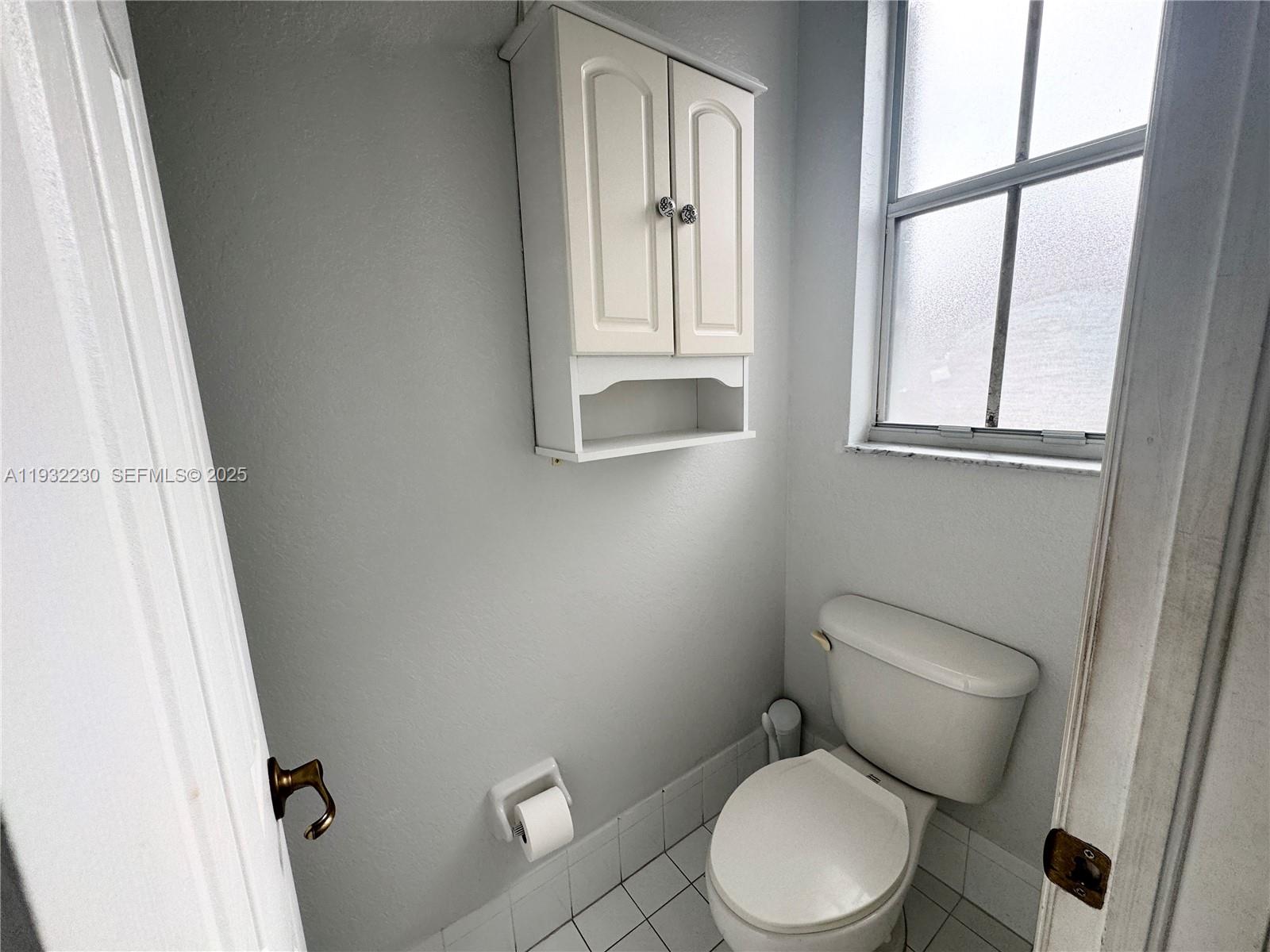 12283 Southwest 123rd Terrace Miami, FL 33186 - Photo 41 of 46 a white toilet sitting next to a window in a bathroom