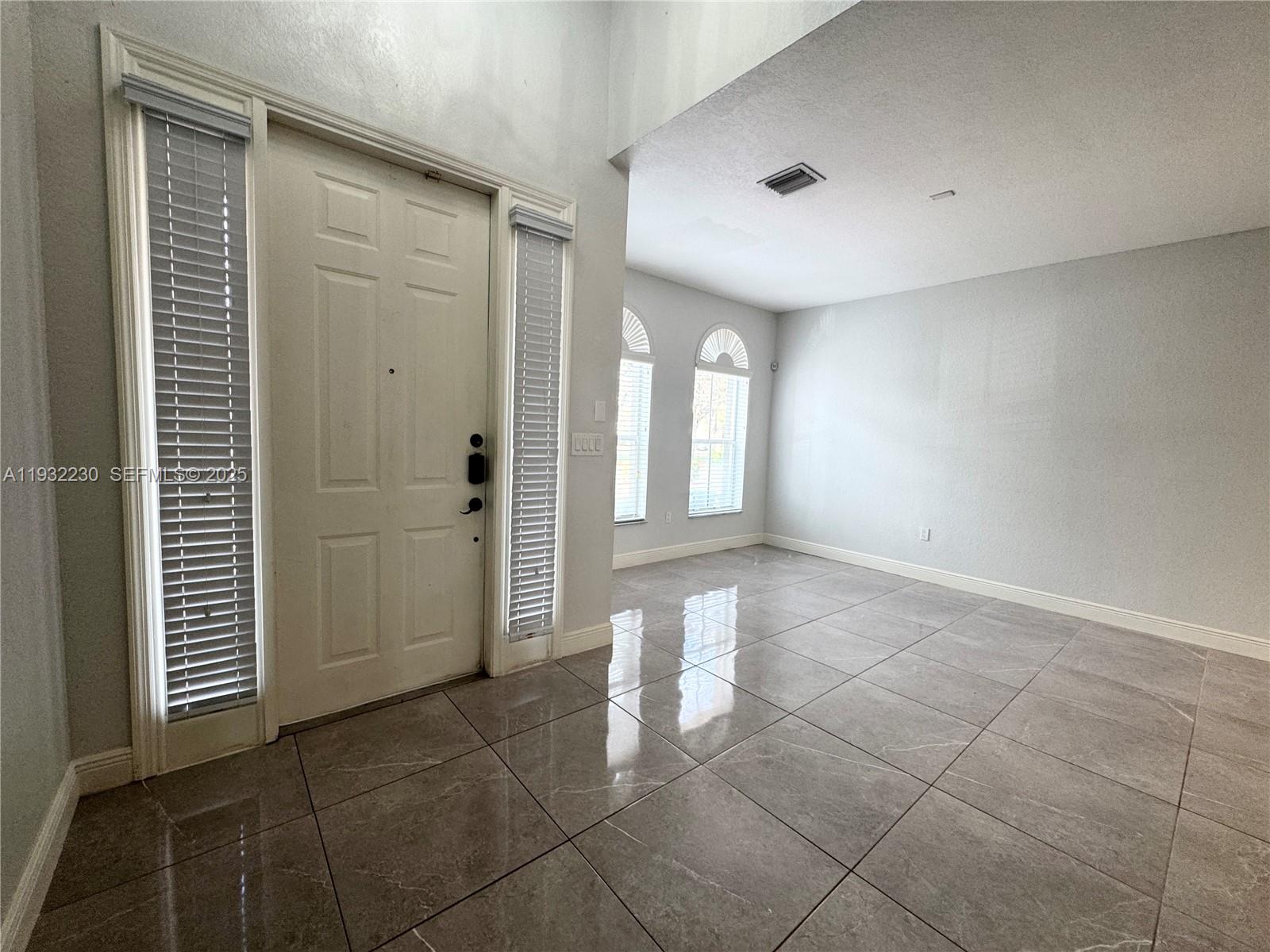 12283 Southwest 123rd Terrace Miami, FL 33186 - Photo 9 of 46 a view of a big room with windows and cabinet