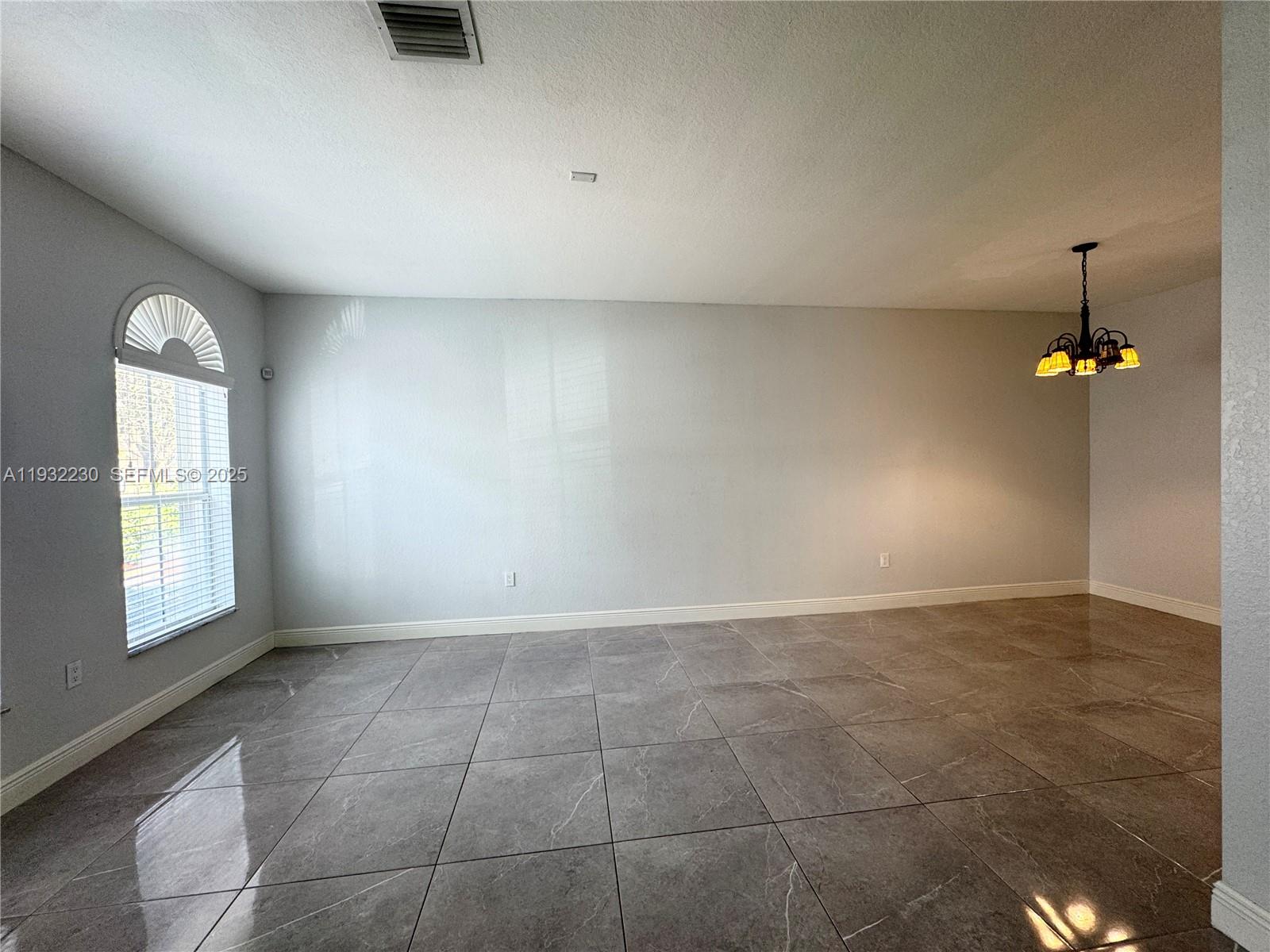 12283 Southwest 123rd Terrace Miami, FL 33186 - Photo 10 of 46 an empty room with windows and cabinet