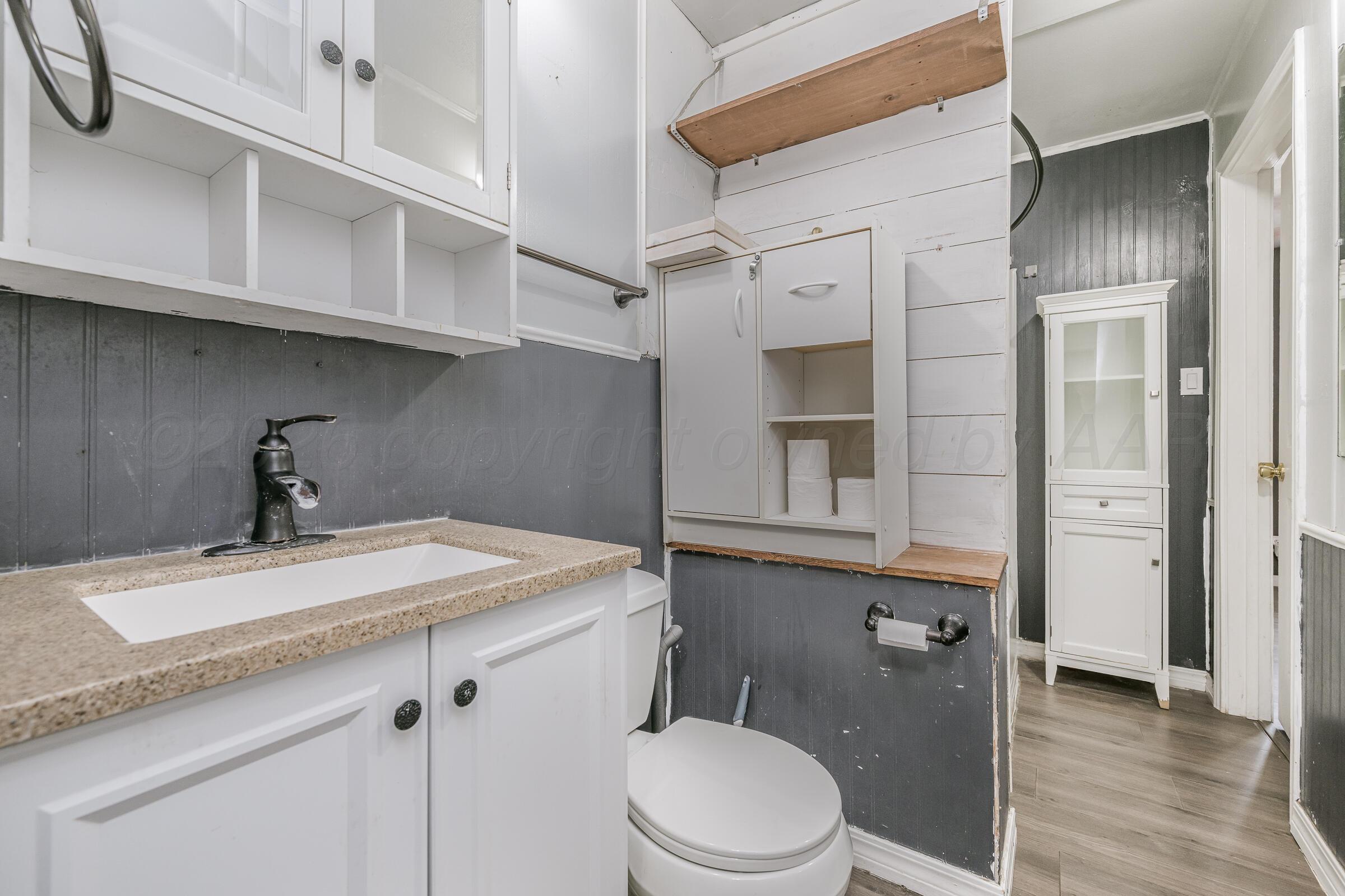 4429 Bowie Street Amarillo, TX 79110 - Photo 13 of 20 a bathroom with a sink a toilet and shower