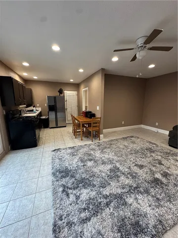 a large kitchen with a large counter top stainless steel appliances and cabinets
