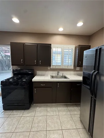a kitchen with a sink a stove and refrigerator