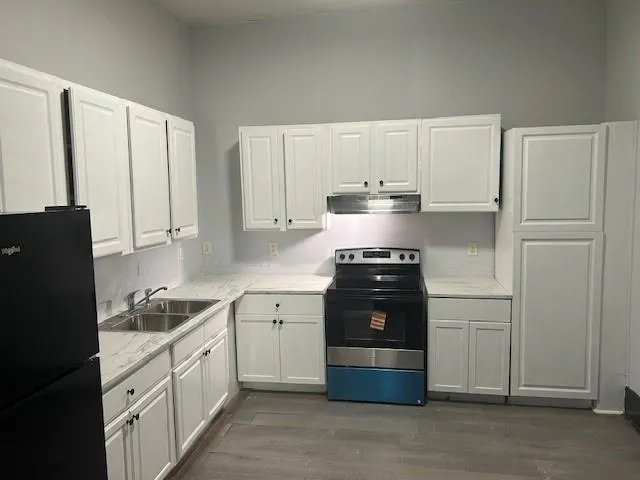a kitchen with a refrigerator and a stove