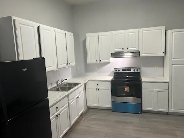 a kitchen with a refrigerator and cabinets