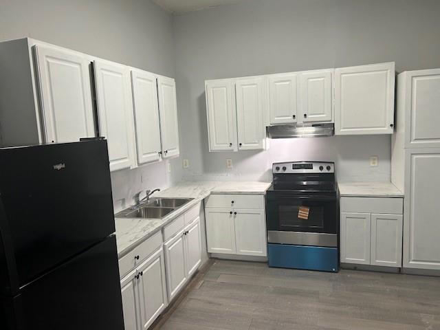 67 Daniel Street Southeast Atlanta, GA 30312 - Photo 13 of 23 a kitchen with a refrigerator and cabinets