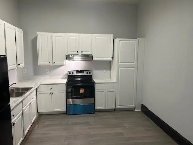 a kitchen with a white cabinets and white appliances