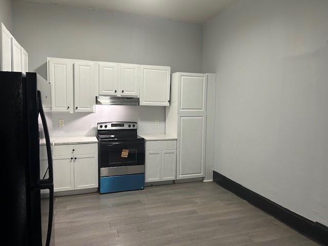 67 Daniel Street Southeast Atlanta, GA 30312 - Photo 16 of 23 a kitchen with a refrigerator stove and white cabinets