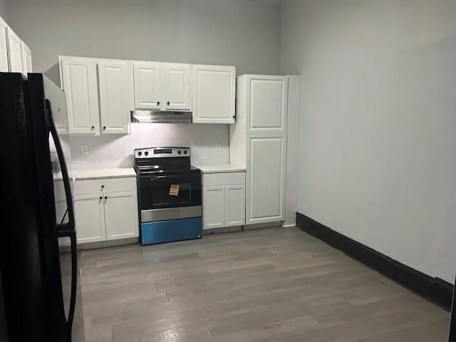 a kitchen with a stove and a refrigerator