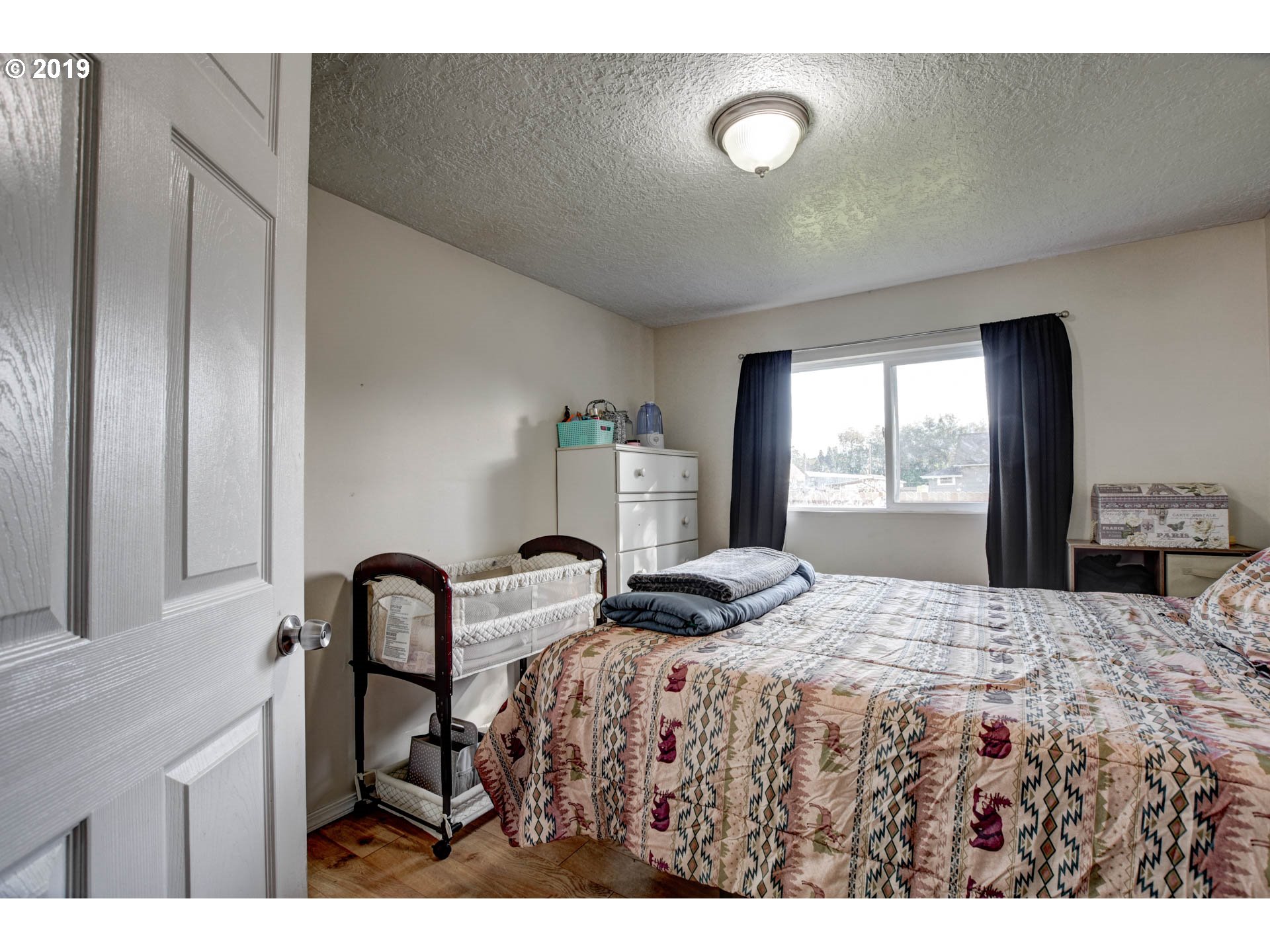 92411 Carnegie Road Astoria, OR 97103 - Photo 16 of 23 a bedroom with a bed and large windows