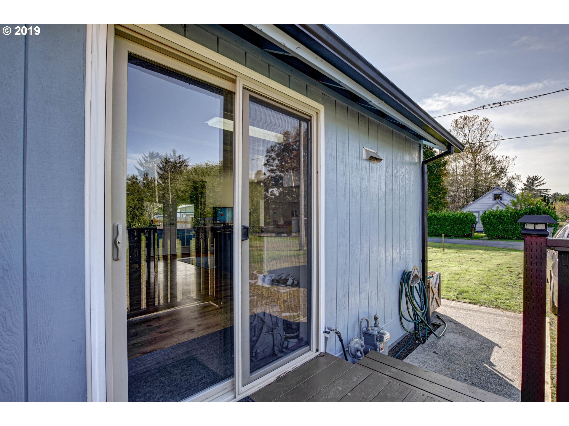 92411 Carnegie Road Astoria, OR 97103 - Photo 3 of 23 a view of backyard with outdoor seating and hardwood