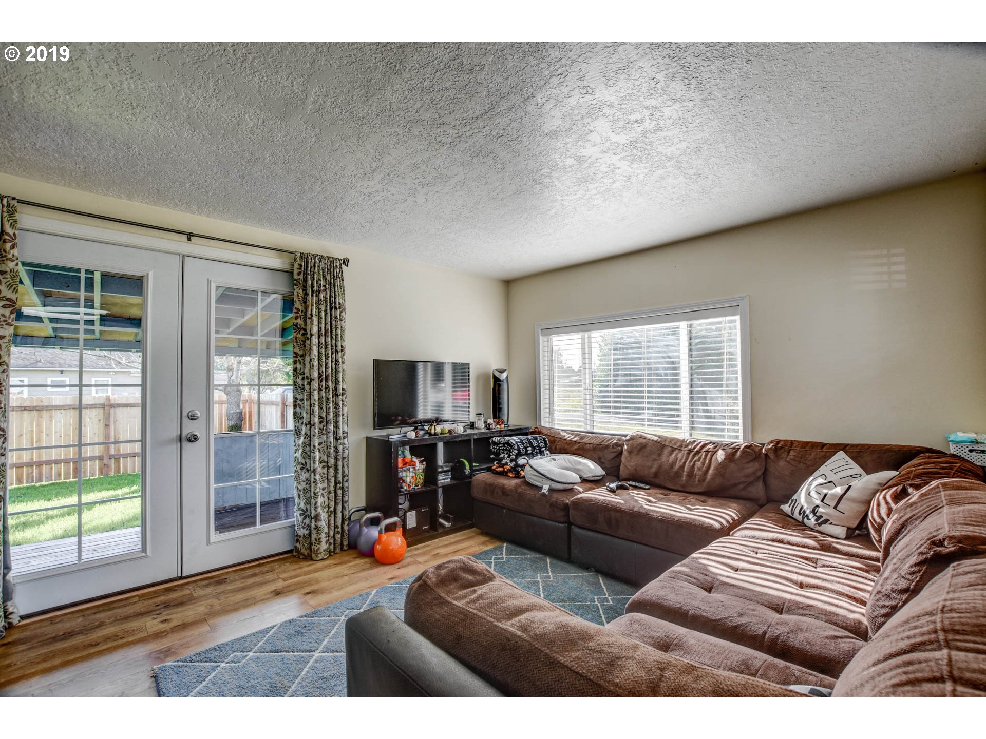 92411 Carnegie Road Astoria, OR 97103 - Photo 8 of 23 a living room with furniture and a flat screen tv
