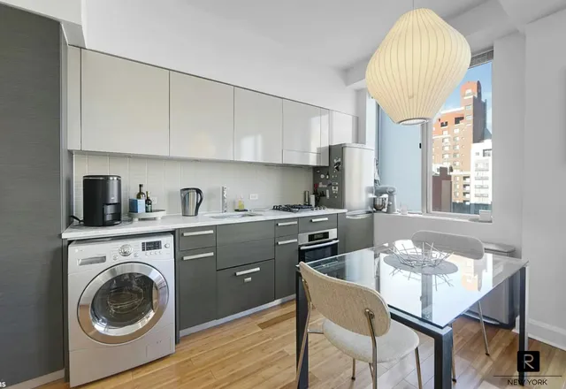 a kitchen with a wooden cabinets and stove top oven