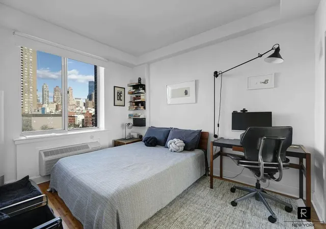 a bedroom with a bed and a desk