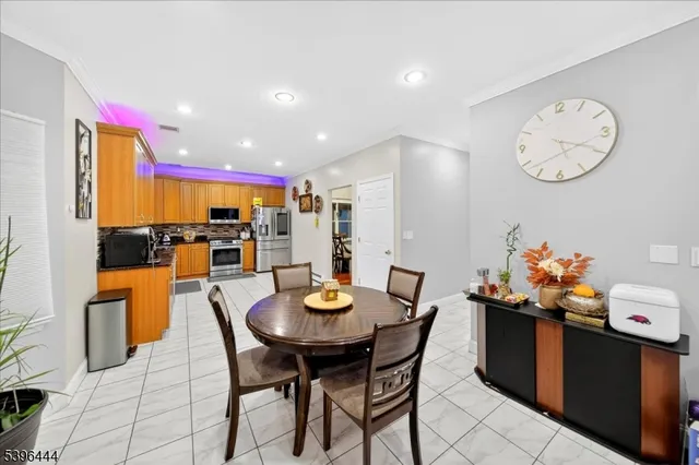 a dining room with furniture and a floor to ceiling window