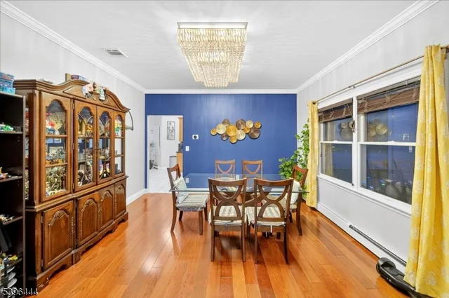 a living room with furniture flowerpot and wooden floor