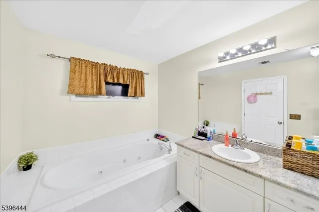 a bathroom with a sink vanity mirror and toilet