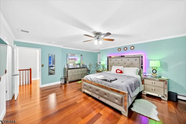 a view of a hallway with wooden floor and stairs