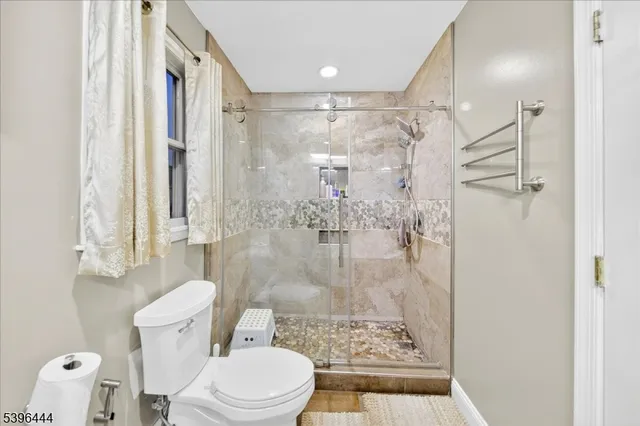 a bathroom with a granite countertop sink a mirror and a shower