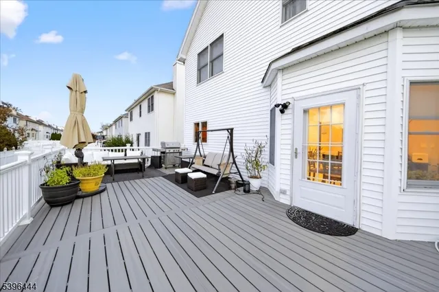 a view of a rooftop deck with couch and chairs