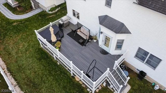 an aerial view of a house with garden space and deck