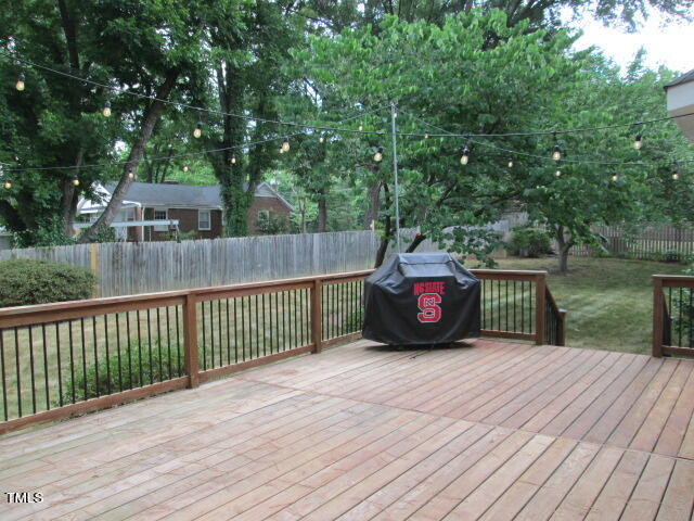 200 Raindrop Court Raleigh, NC 27615 - Photo 13 of 61 a view of a deck with a floor to ceiling window and a yard