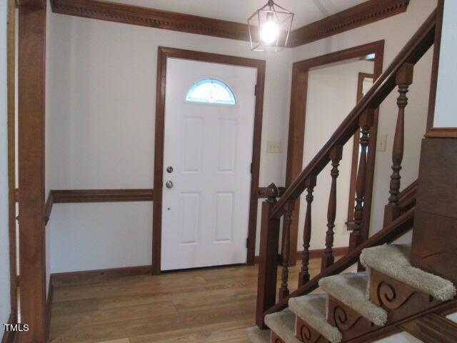 200 Raindrop Court Raleigh, NC 27615 - Photo 14 of 61 a view of front door with wooden floor and stairs