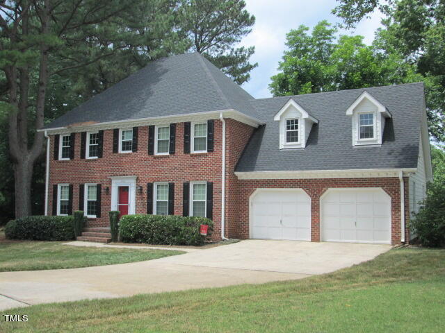 200 Raindrop Court Raleigh, NC 27615 - Photo 2 of 61 a front view of a house with a yard and garage