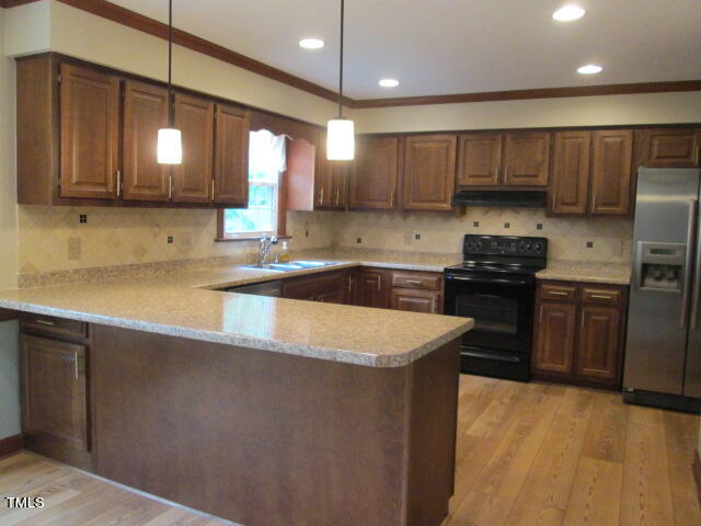 200 Raindrop Court Raleigh, NC 27615 - Photo 21 of 61 a kitchen with stainless steel appliances granite countertop a sink a stove and a refrigerator
