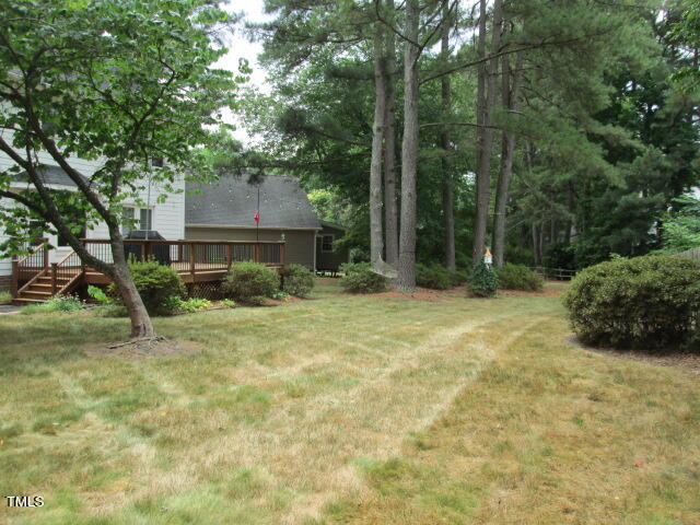 200 Raindrop Court Raleigh, NC 27615 - Photo 9 of 61 a backyard of a house with plants and large tree