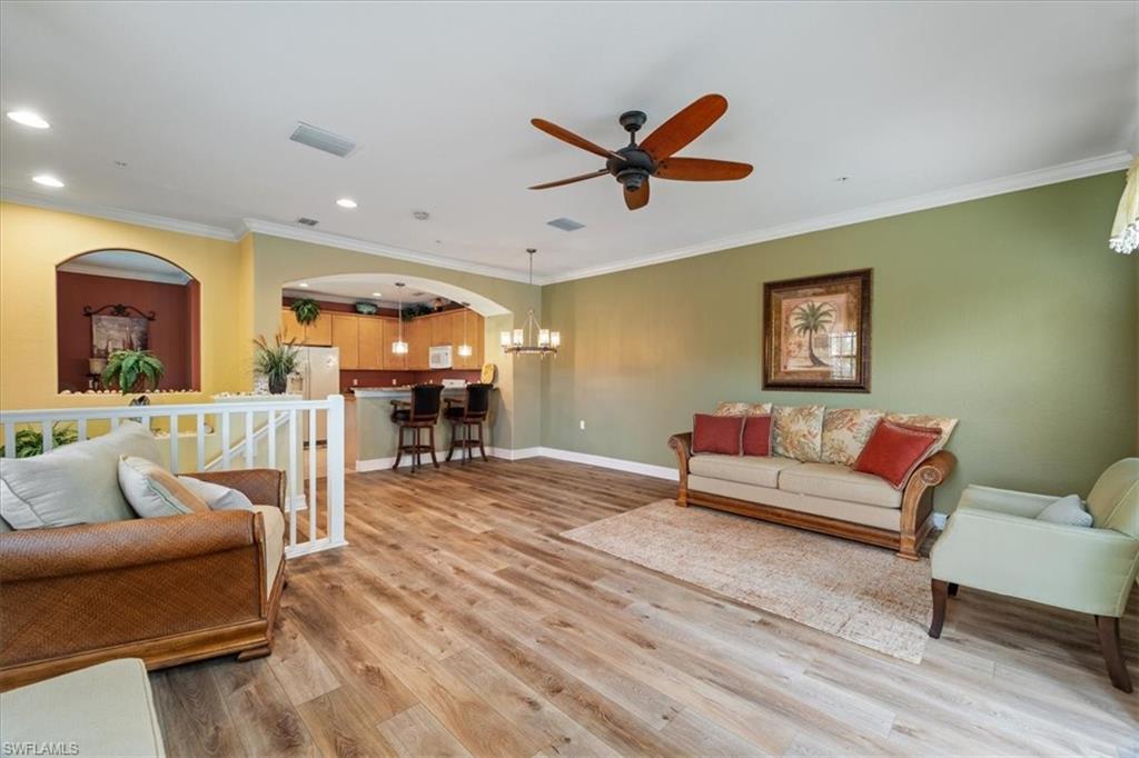 9091 Covina Drive South, Unit 6904 Naples, FL 34113 - Photo 13 of 46 a living room with furniture and a wooden floor