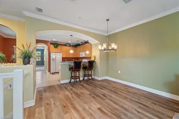 a view of a kitchen with a table and chairs