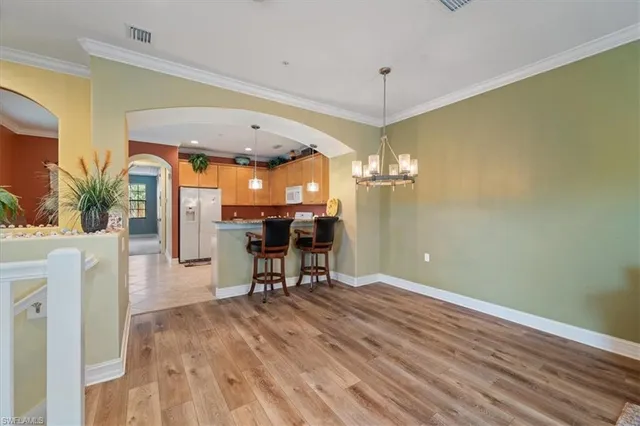 a view of a kitchen with a table and chairs