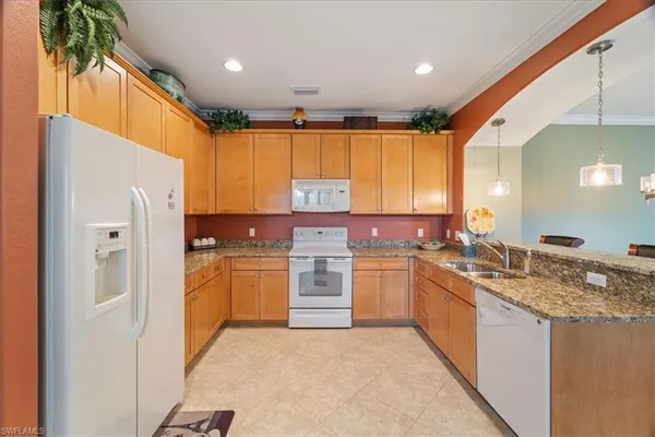 a kitchen with a stove top oven sink and cabinets