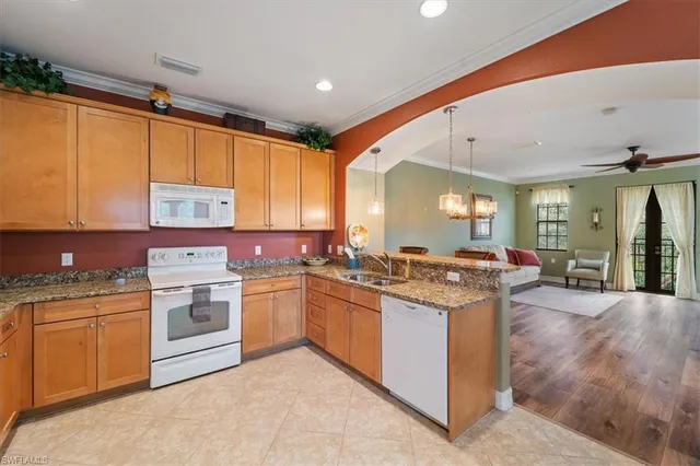 a kitchen with sink and view of living room