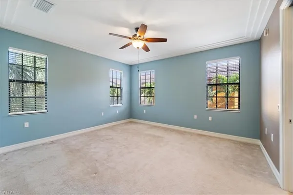 a view of an empty room with a ceiling fan