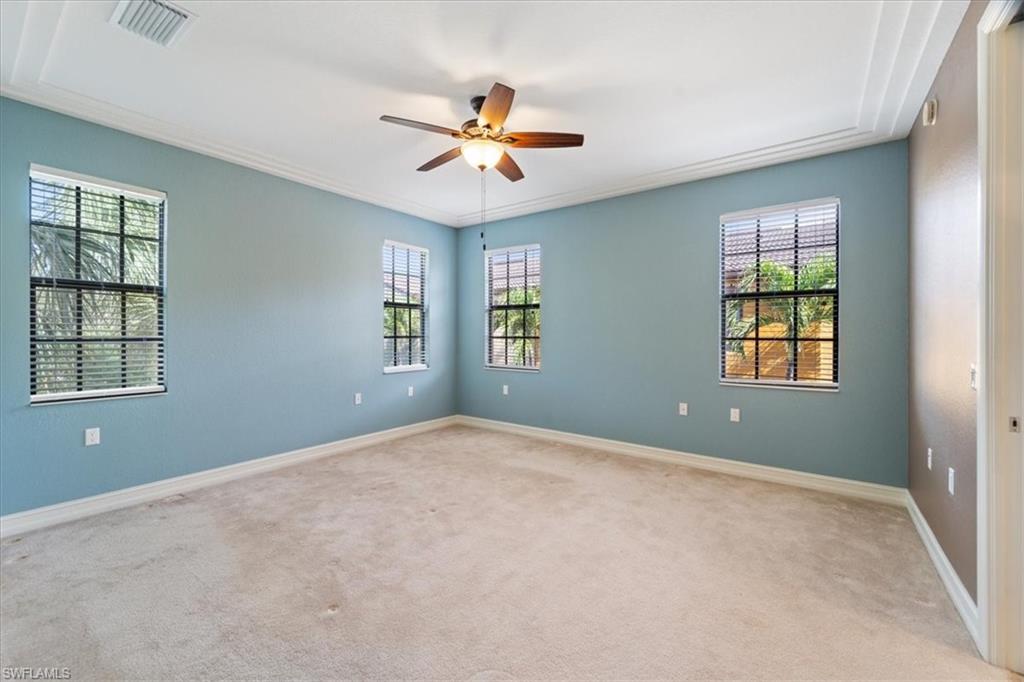 9091 Covina Drive South, Unit 6904 Naples, FL 34113 - Photo 23 of 46 a view of a livingroom with a ceiling fan and window