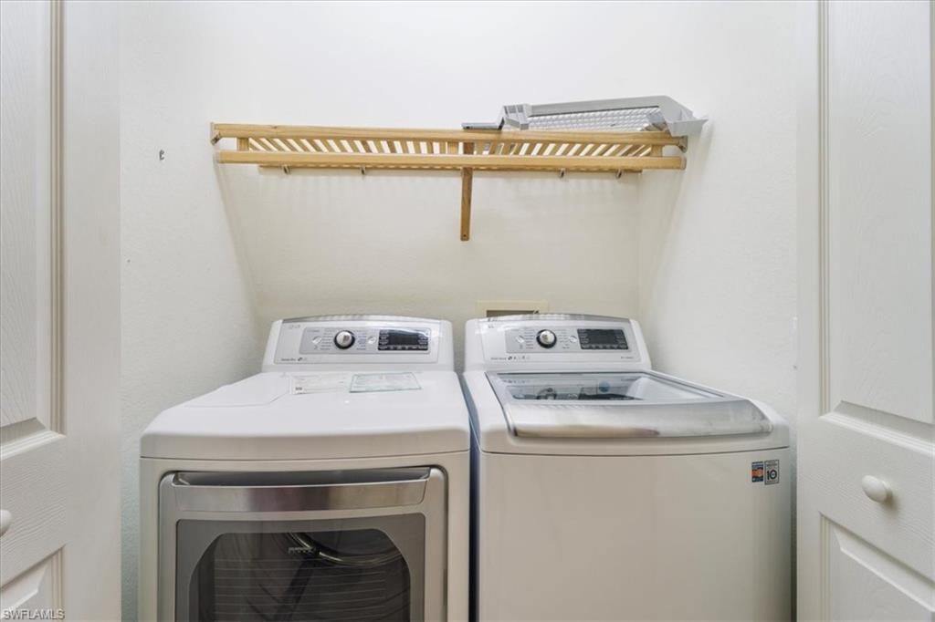 9091 Covina Drive South, Unit 6904 Naples, FL 34113 - Photo 26 of 46 a utility room with dryer and washer