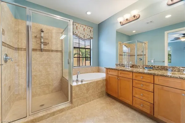 a bathroom with a granite countertop sink mirror and toilet