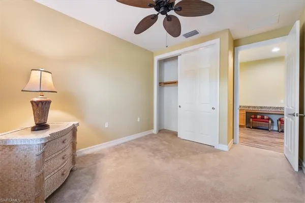 a bedroom with two beds and a chandelier