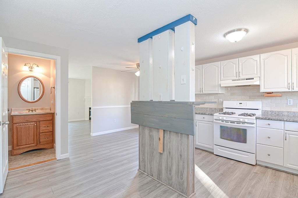 2743 Cranberry Highway, Unit 2D Wareham, MA 02571 - Photo 14 of 37 a kitchen with a stove a sink and a refrigerator