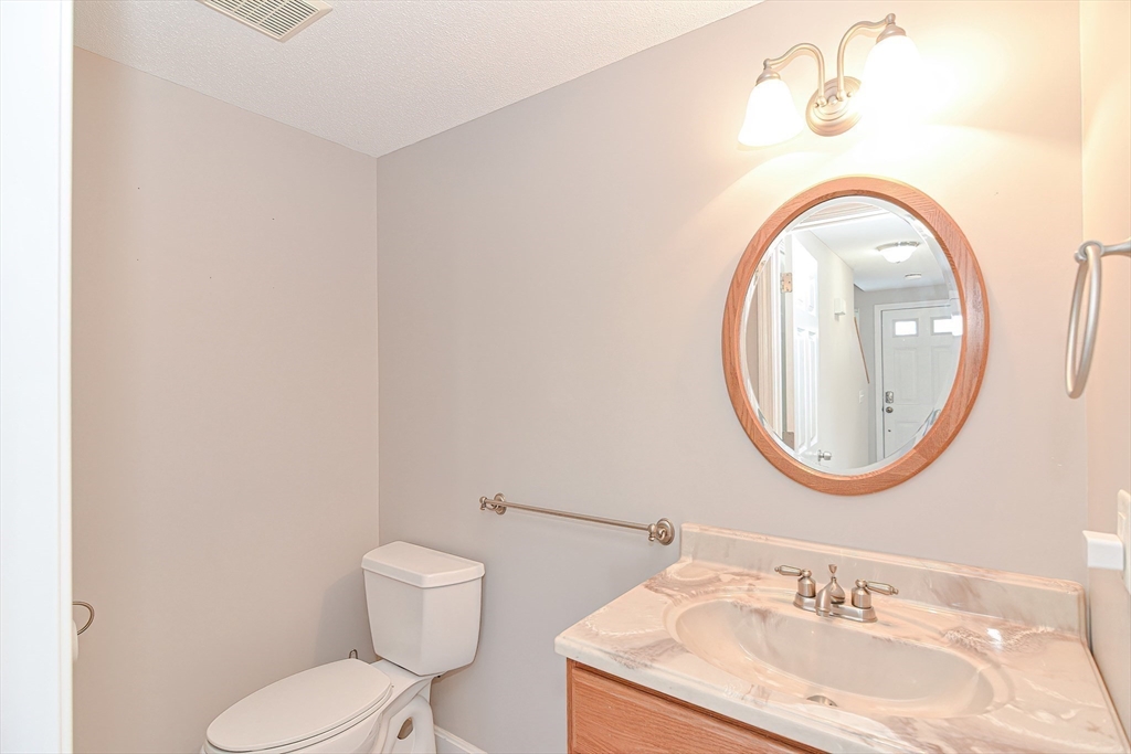 2743 Cranberry Highway, Unit 2D Wareham, MA 02571 - Photo 15 of 37 a bathroom with a sink mirror and toilet