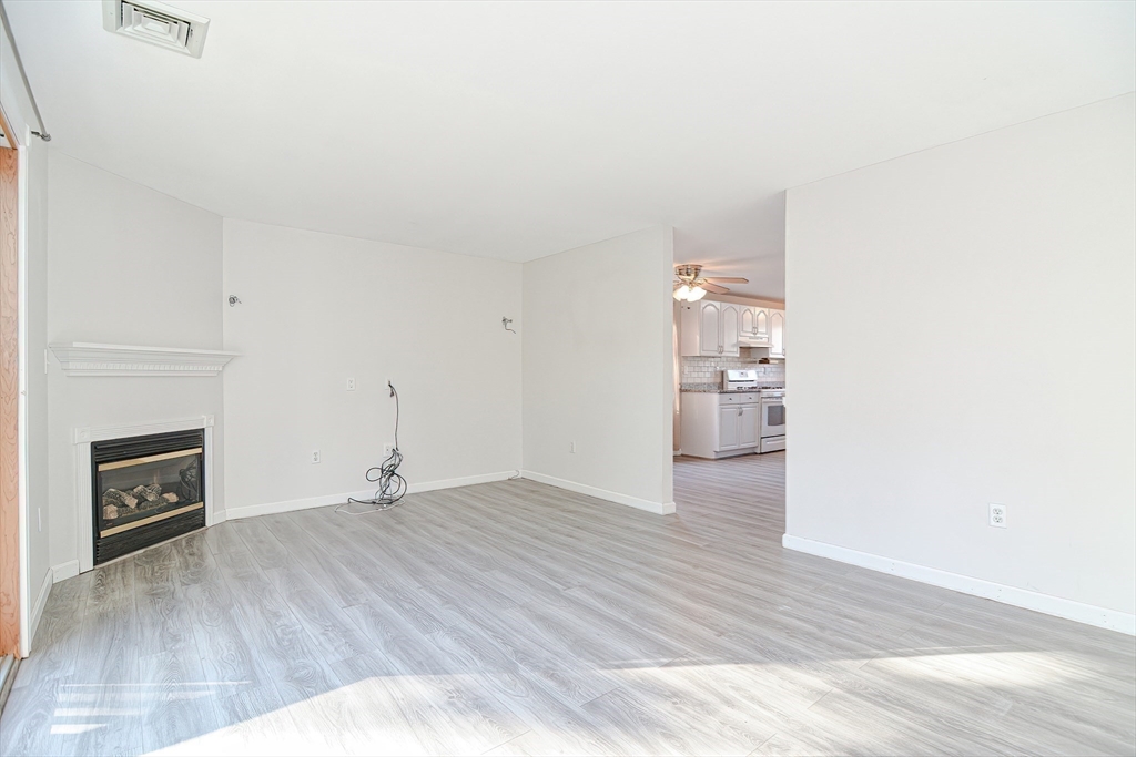 2743 Cranberry Highway, Unit 2D Wareham, MA 02571 - Photo 18 of 37 a view of empty room with wooden floor and fireplace