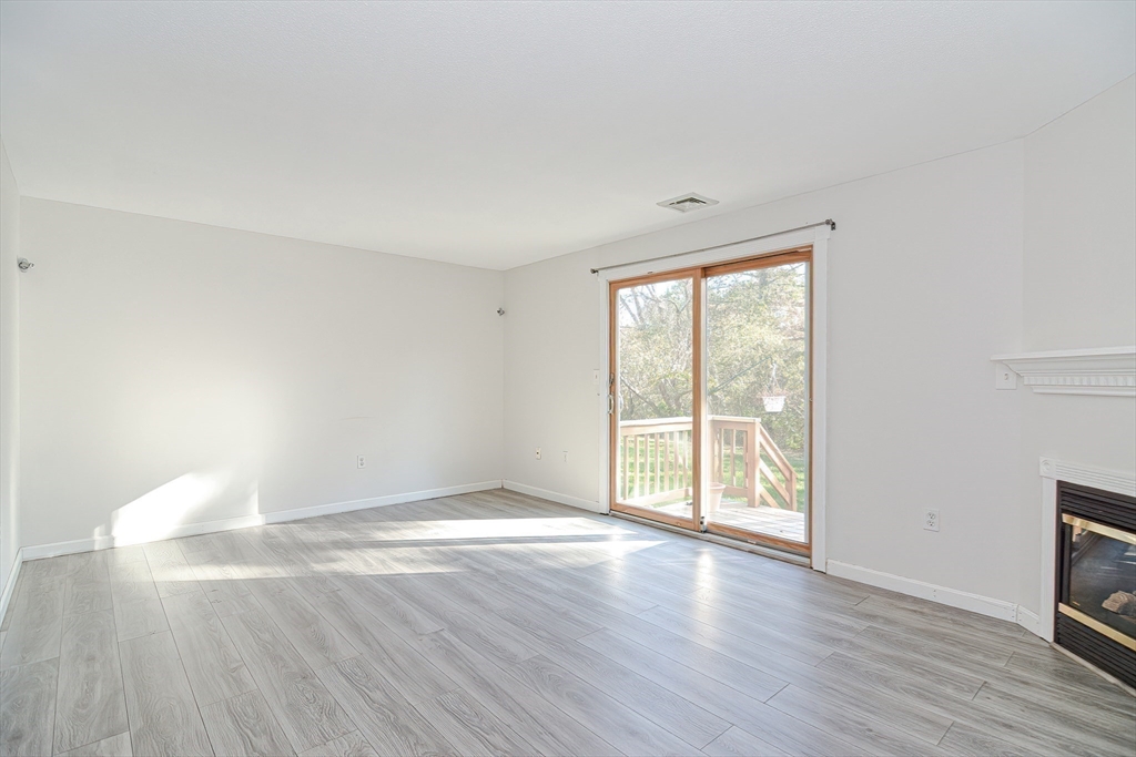 2743 Cranberry Highway, Unit 2D Wareham, MA 02571 - Photo 21 of 37 a view of an empty room with wooden floor and a window