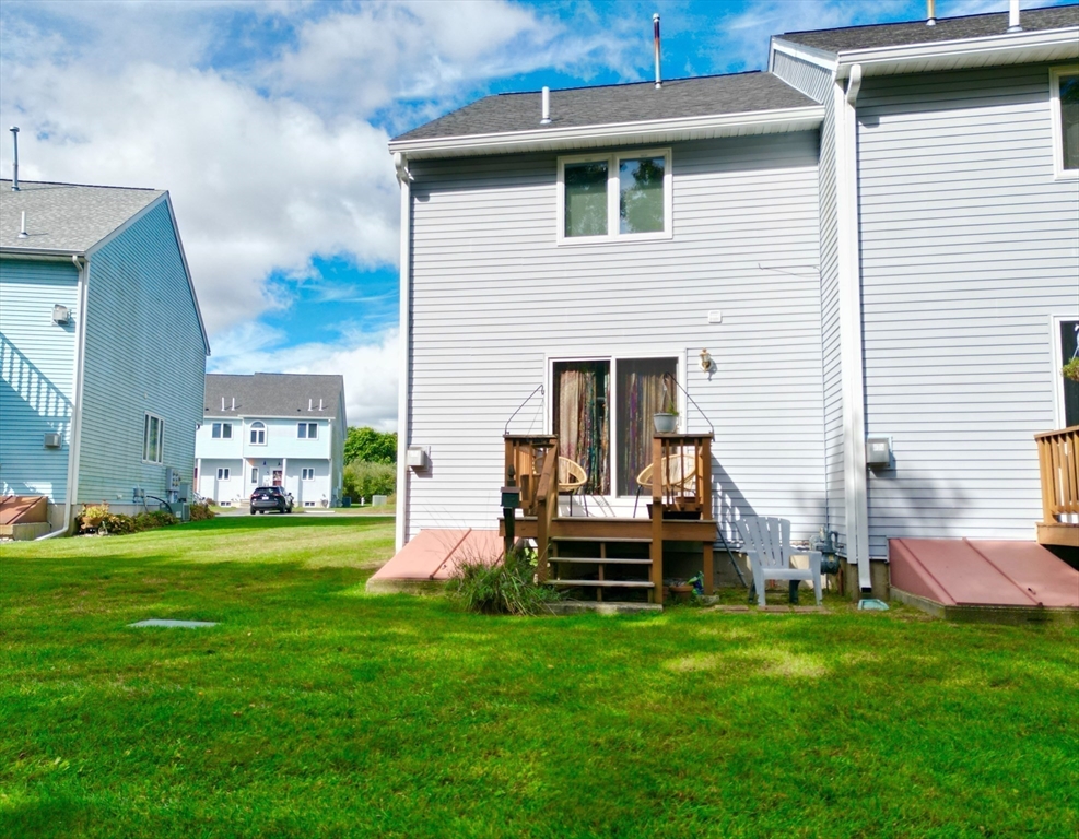 2743 Cranberry Highway, Unit 2D Wareham, MA 02571 - Photo 35 of 37 a view of a house with a yard and sitting area