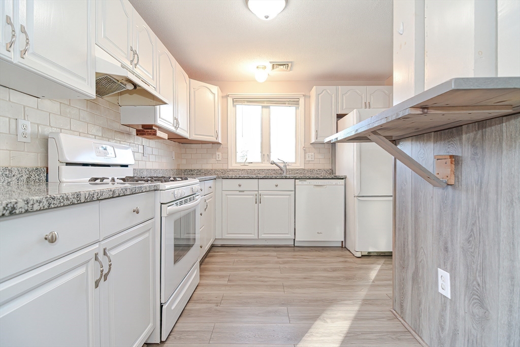 2743 Cranberry Highway, Unit 2D Wareham, MA 02571 - Photo 10 of 37 a kitchen with granite countertop a sink and cabinets