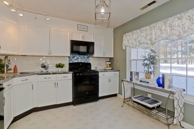 a kitchen with a sink appliances and cabinets