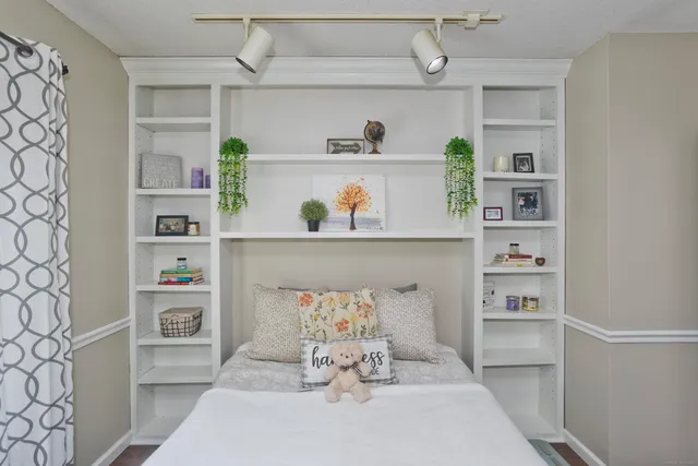 a shelf with books and knick knacks on it