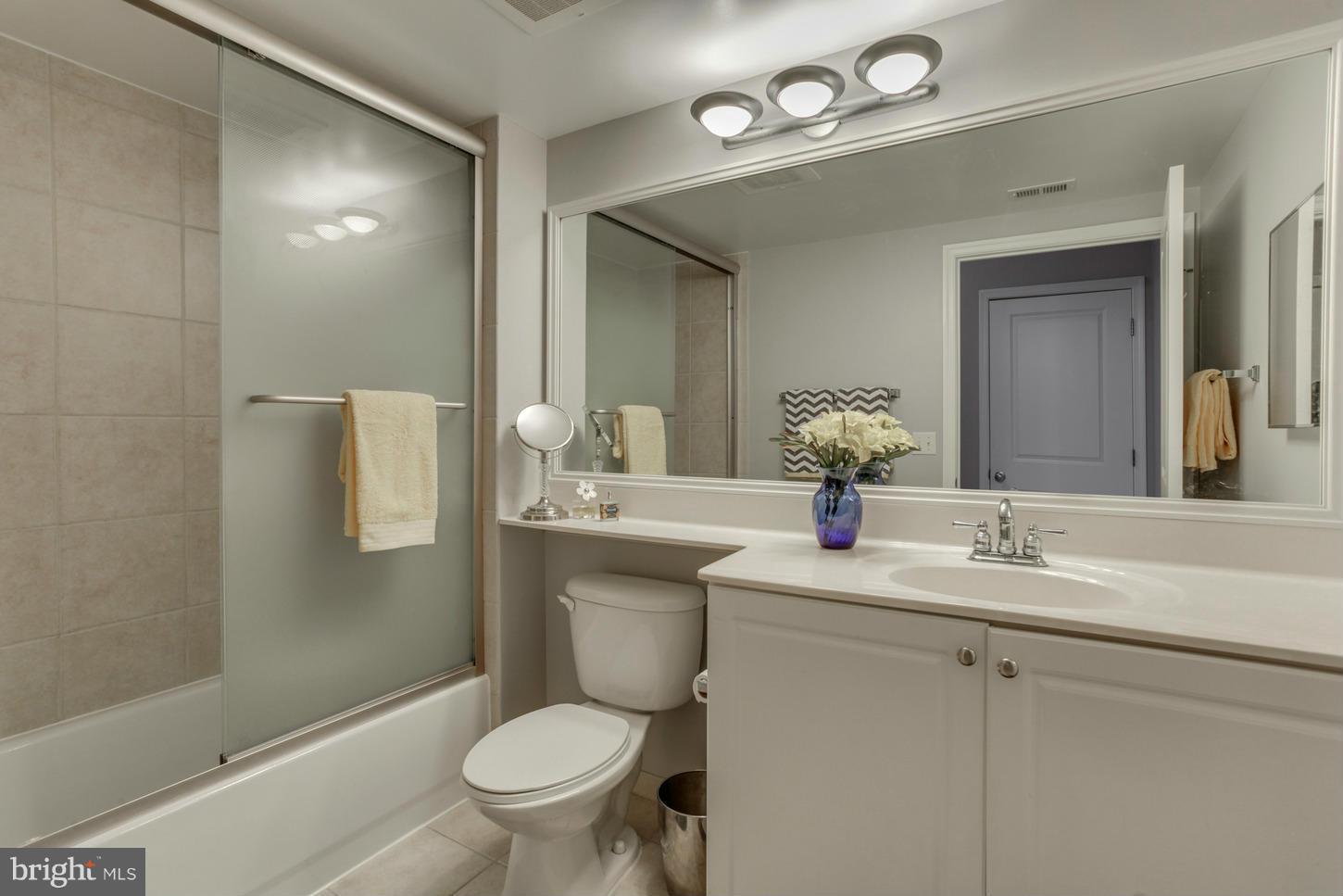 851 North Glebe Road, Unit 1010 Arlington, VA 22203 - Photo 11 of 30 a bathroom with a toilet a sink and mirror