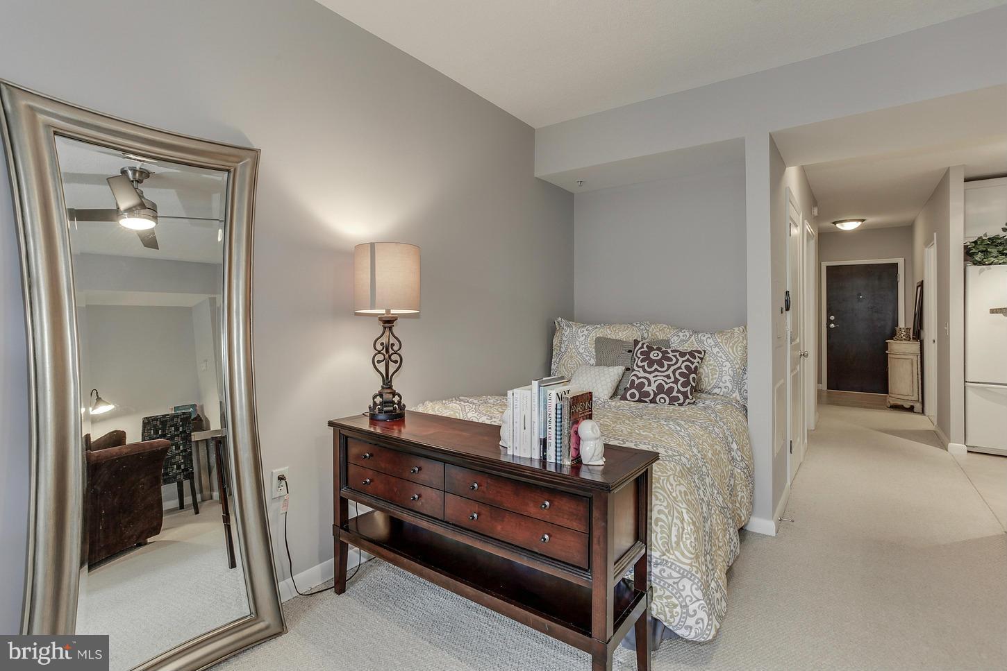 851 North Glebe Road, Unit 1010 Arlington, VA 22203 - Photo 12 of 30 a bedroom with a bed and a lamp