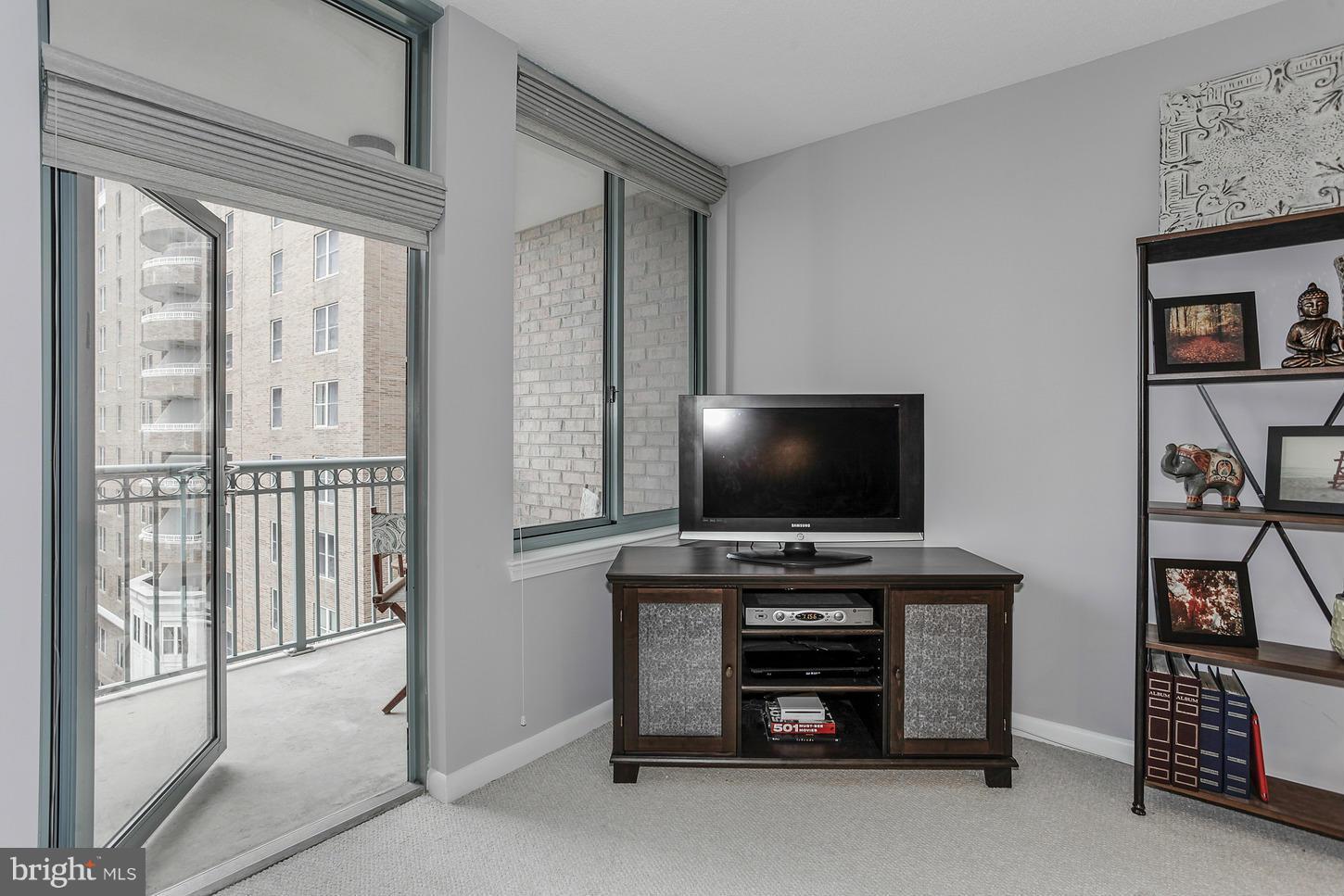 851 North Glebe Road, Unit 1010 Arlington, VA 22203 - Photo 15 of 30 a room with furniture and flat screen tv